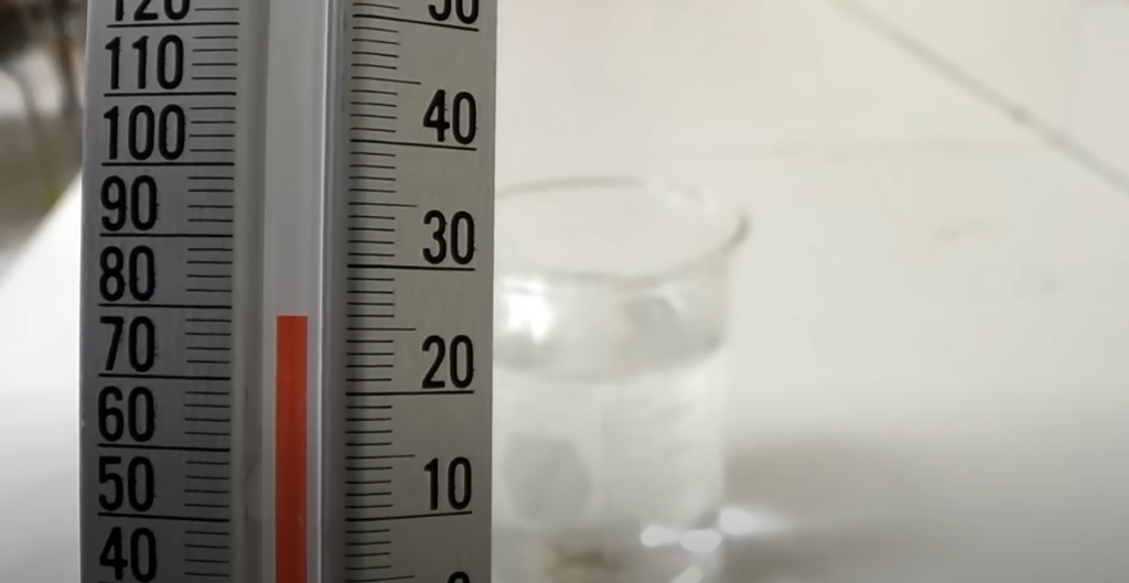 Thermometer with a blurred beaker in the background