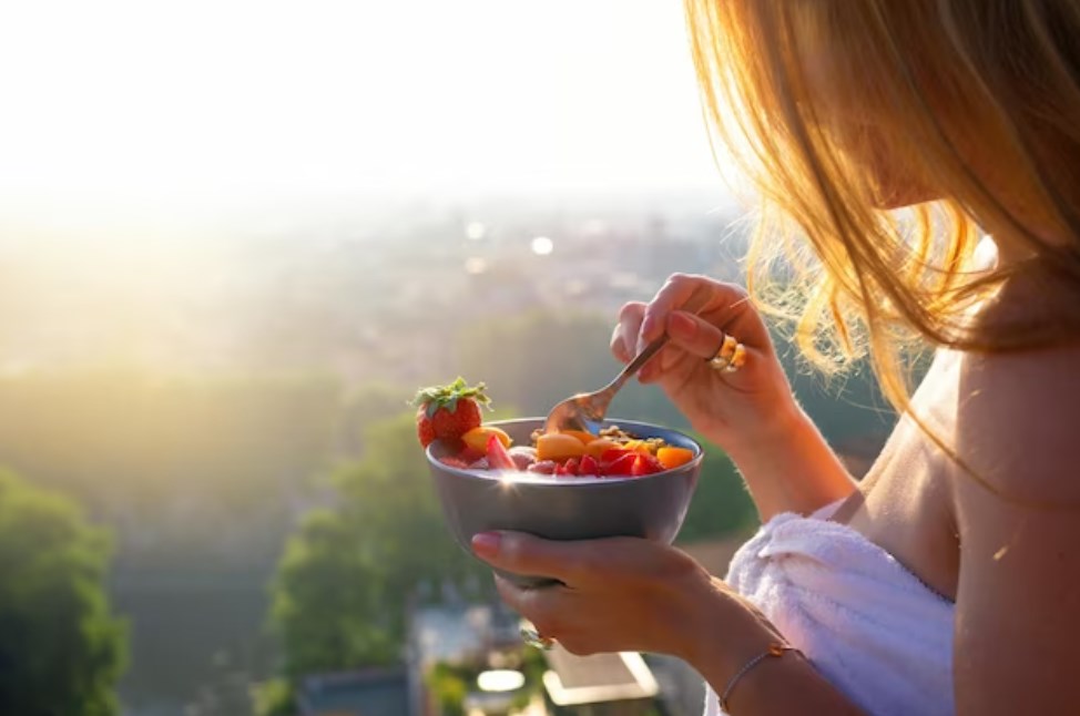 a woman starting a day with a healthy strawberry breakfast