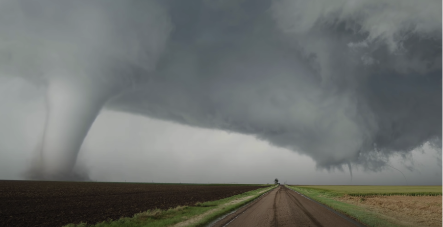An image capturing a tornado in clear view from an open field.
