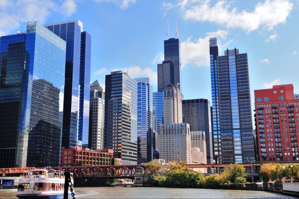 a river with a floating ferry and skyscrapers in Chicago