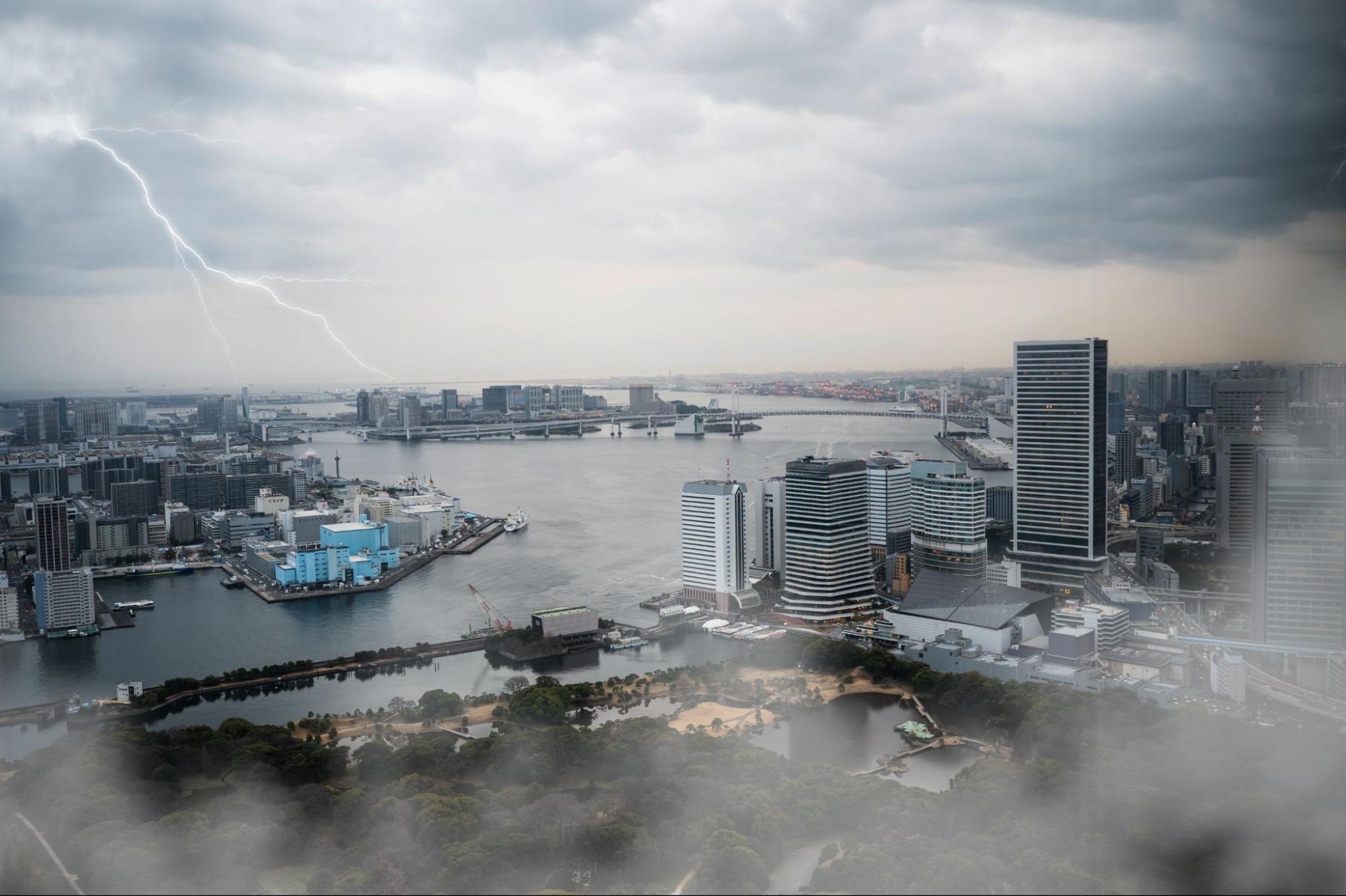 weather effects in a collage concept depicting a city with skyscrapers and a river